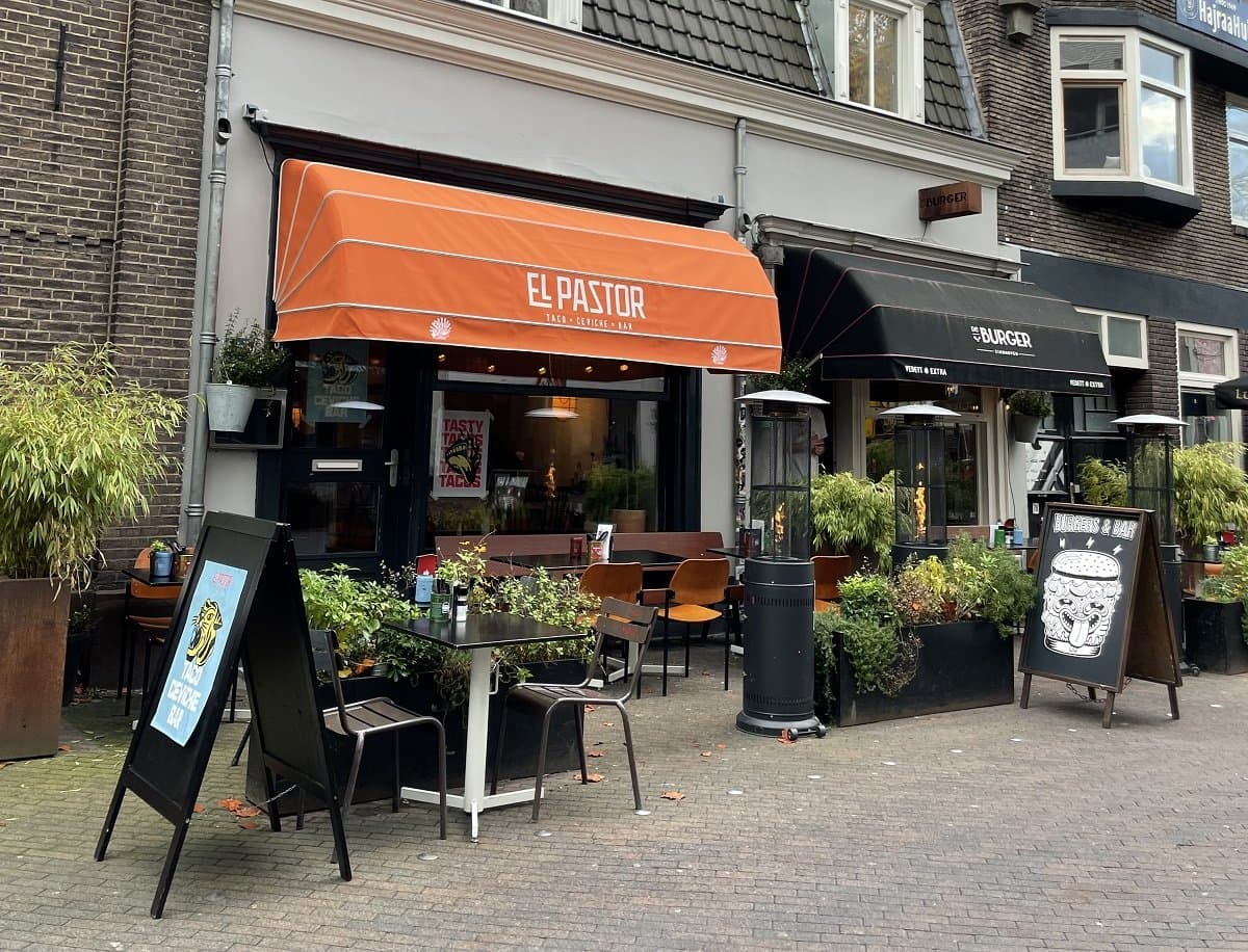 Gevel van restaurant El Pastor in Eindhoven met oranje luifel en terras